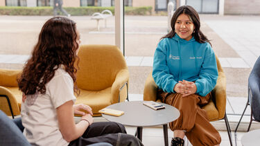 A Res Life mentor chatting with residents